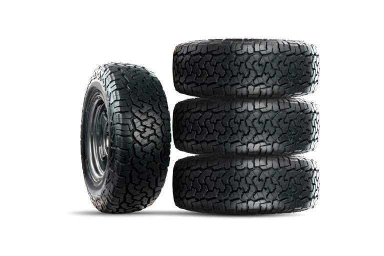 Set of 4 wheels car tires designed for use in all road conditions isolated on white background.